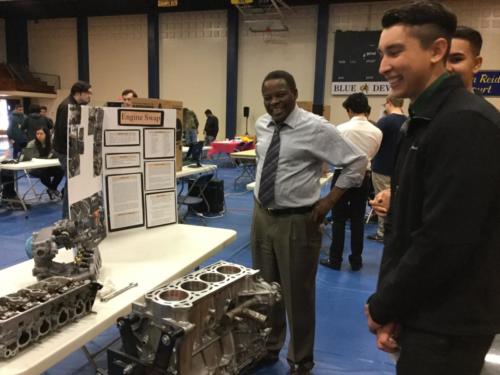 Shawn Flannigan and Sukhpreet Singh showing off their Engine Swap project to Merced College Administrator Dr. Baba Adam!