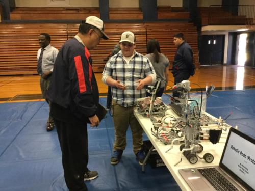 Cary Yanagi judges a project from Hilmar High School